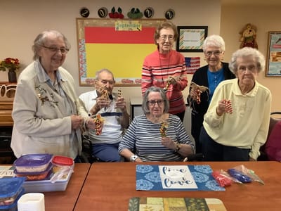 Residents engaging in a crafting activity around a table