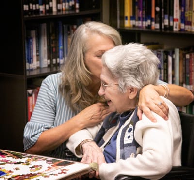 Staff member sharing a moment with a resident during an activity.