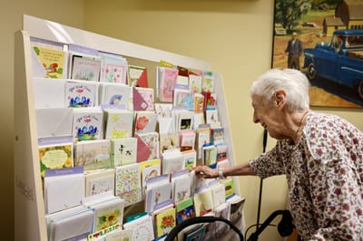 Resident looking at greeting cards in a common area