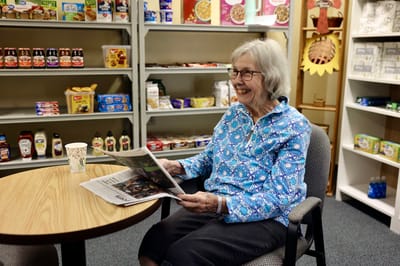 Resident enjoying a newspaper in a common area