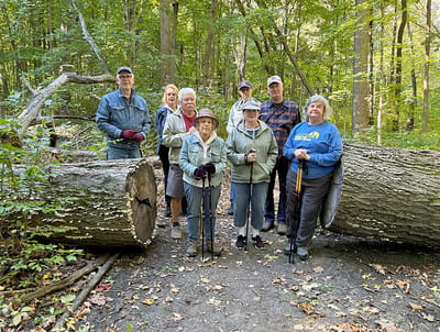 Residents enjoying a nature walk in the woods