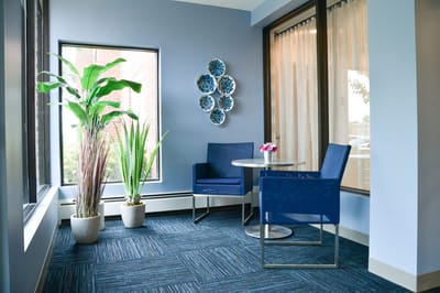 Bright corner seating area with plants and decor