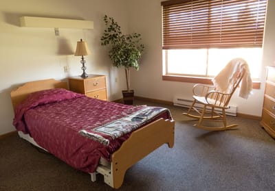 Cozy resident room with bed and rocking chair