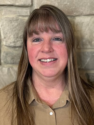 Staff member smiling in a friendly environment