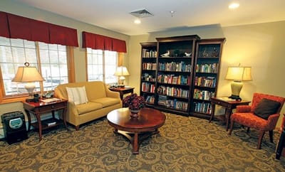Cozy common area with seating and bookshelves