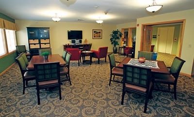 Cozy common area with tables and chairs.