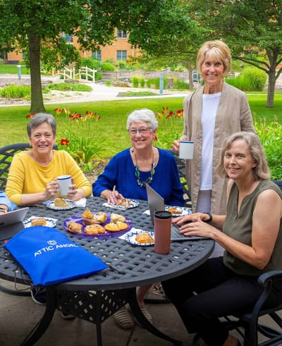 Residents enjoying refreshments in a garden area