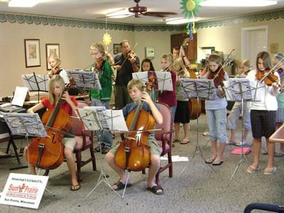 Children performing music in a common area