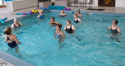 Residents participating in a water aerobics class