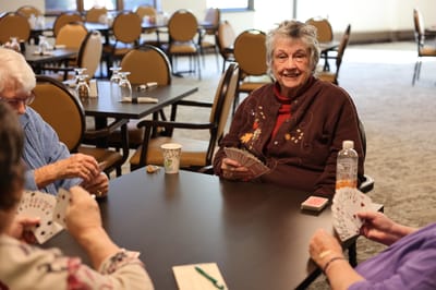 Residents enjoying a card game in a common area