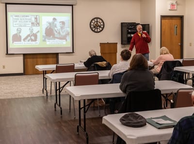 Residents attending a presentation in a common room