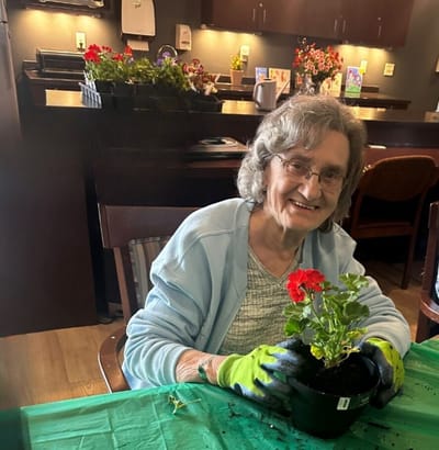 Resident potting flowers in an activity room