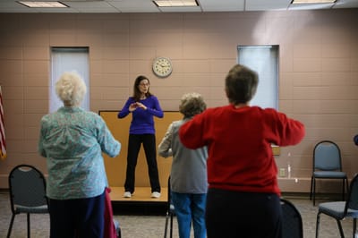 Residents participating in an exercise session indoors