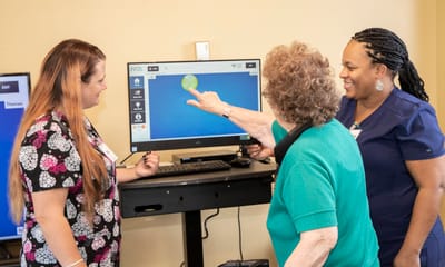 Staff and resident engaging with a digital activity