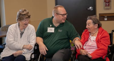 Staff member conversing with residents in a common area