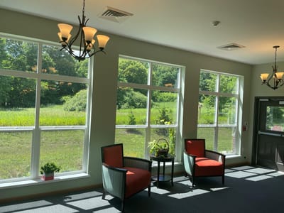 Bright interior lounge with large windows and comfortable seating