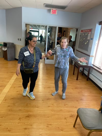 Staff assisting resident in common area