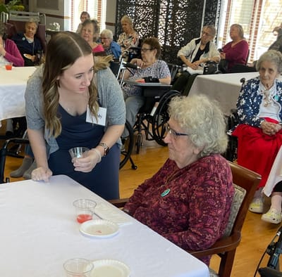 Staff member engaging with a resident during an activity