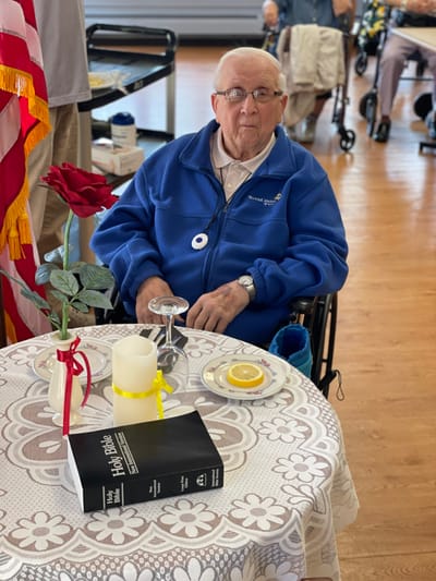 An elderly man in a cozy common area with decorations