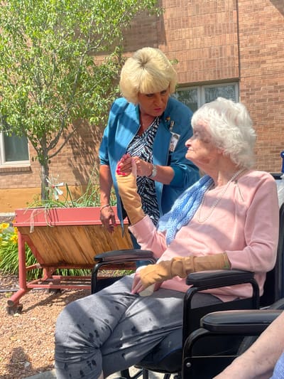 Staff member assisting a resident outdoors