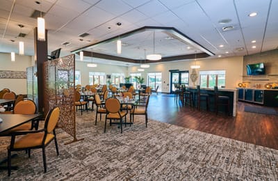 Dining area with tables and chairs, well-lit space