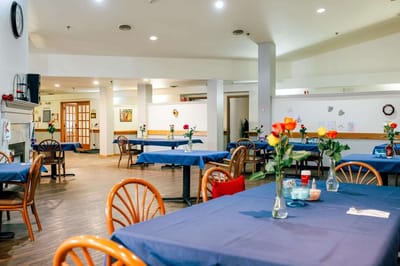 Bright dining area with tables and flower centerpieces