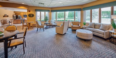 Bright common area with seating and large windows