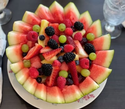 A colorful fruit salad display served in a watermelon