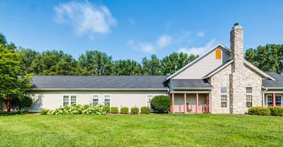 Exterior view of a senior living building with landscaped lawn