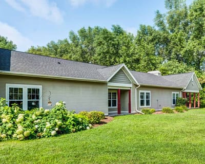 Exterior view of a senior living facility with gardens