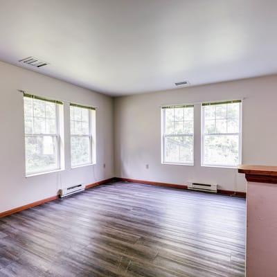 Empty living room with windows and hardwood floor