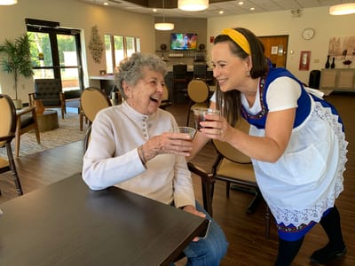 Staff member serving beverages to resident in common area