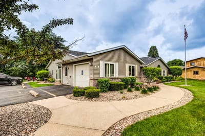 Exterior view of the assisted living facility with landscaped garden