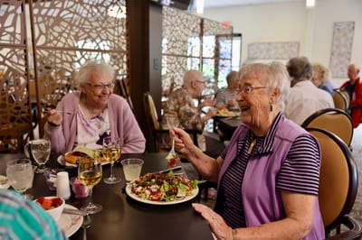 Residents enjoying a meal in the dining room