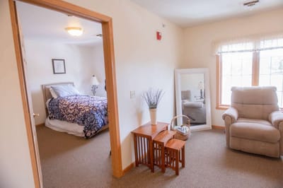 Private resident room with bed and comfortable seating