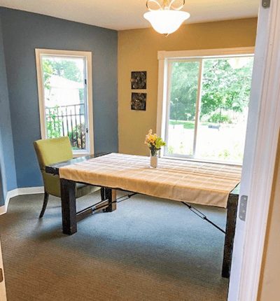 Bright common area with a table and chairs