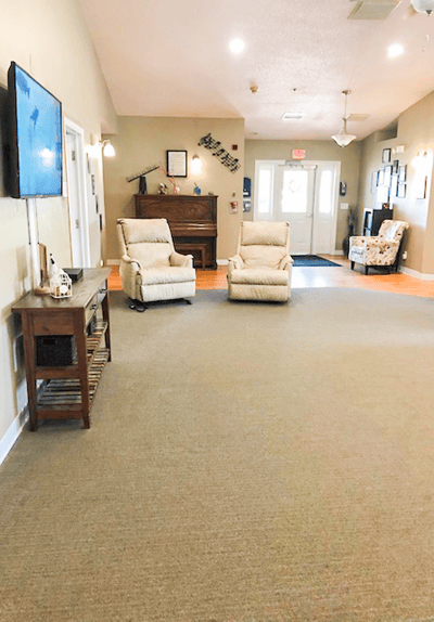 Quiet common area with seating and a piano