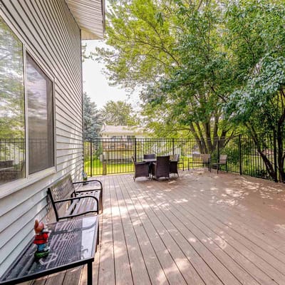 Outdoor patio area with seating and greenery