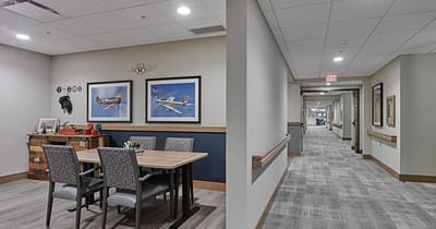 Bright common area with a table and art on the walls