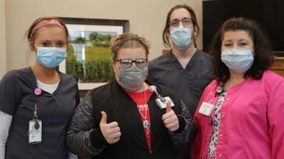 Staff members posing together in a common area