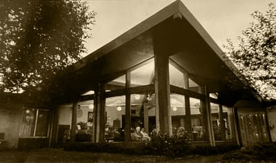 Exterior view of Chippewa Manor with residents visible inside