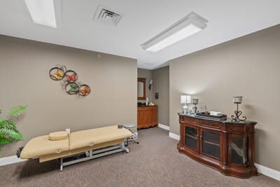 Spa room with massage table and decor.