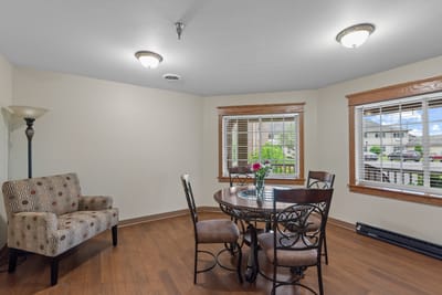 Bright common area with seating and dining table