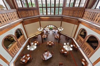 View of the dining room with tables and chandeliers