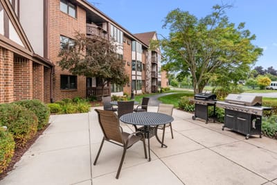 Outdoor seating area with tables and grill