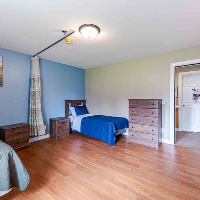 Spacious resident room with two beds and dressers