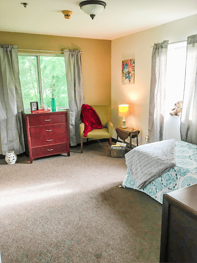 A private resident room with a cozy seating area