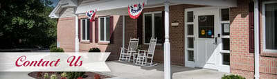 Building entrance with rocking chairs and decorations