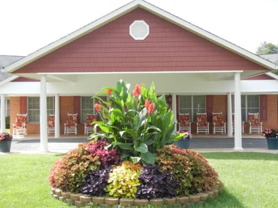Exterior view of a senior care facility entrance with garden