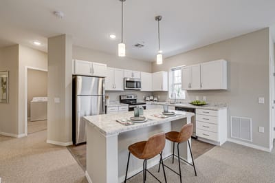 Modern kitchen with dining space in a senior living facility